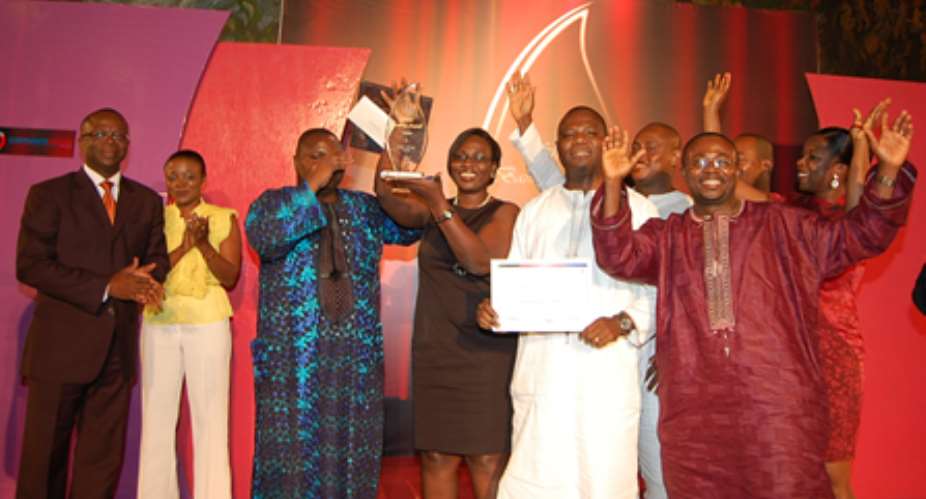 Excited staff of GT Bank display their certificate and plaque at the ceremony