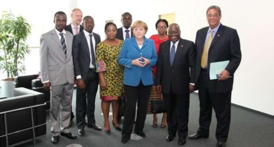 Angela Merkel in blue jacket flanked by Nana Addo to her left and Ayorkor Botcway to her right.