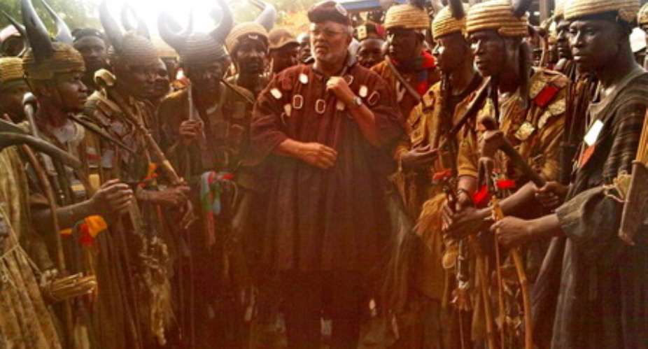 Ex-President Rawlings in traditional battle garb as he poses with the warriors