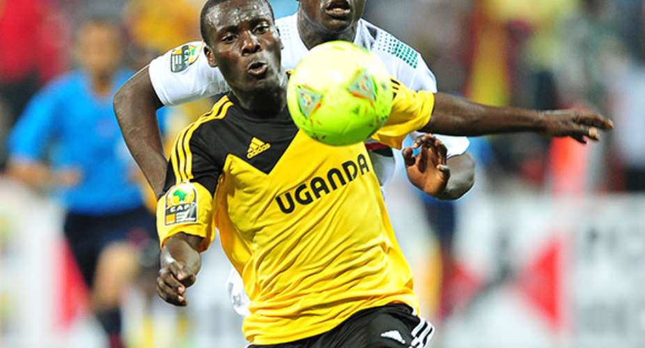 Isaac Muleme of Uganda gets to the ball ahead of Bassirou Ouedraogo of Burkina Faso.