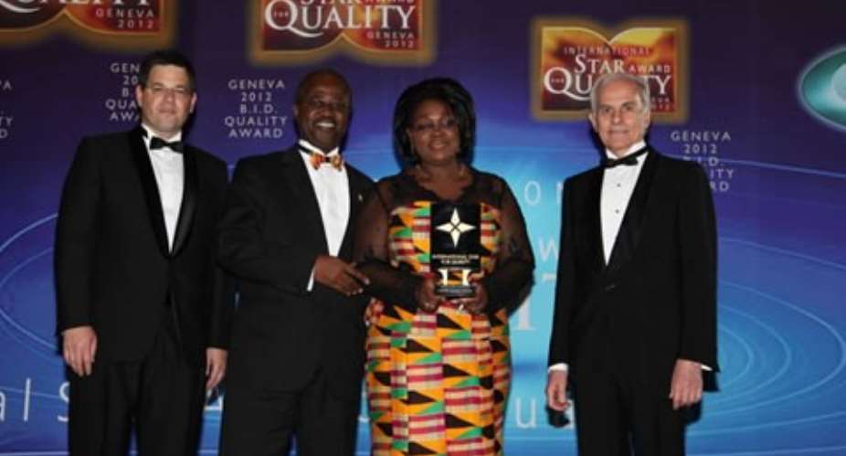 Mrs. Ellen Hagan (m)receiving the award on behalf of LAINE Services Ltd