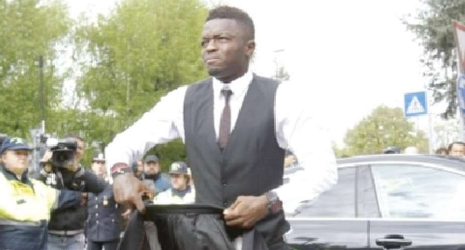 Time for serious business: Sulley Muntari arrives at his office, 4FK MotorSport, where cars are pimped for millionaires and super stars.