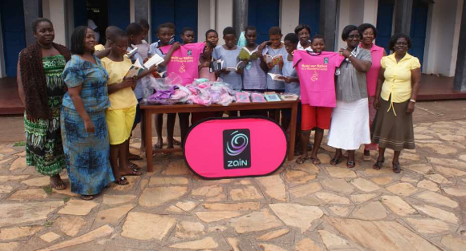 Representatives from the Girl Child Education Unit of the Ghana Education Service and participants admiring samples of the educational materials and T-shirts donated by Zain