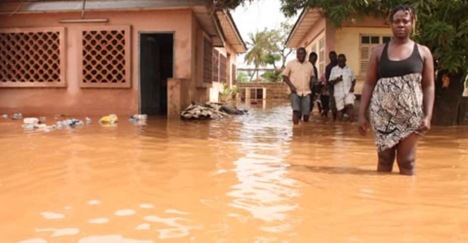 Mr. Denkyi and some residents affected by the floods.