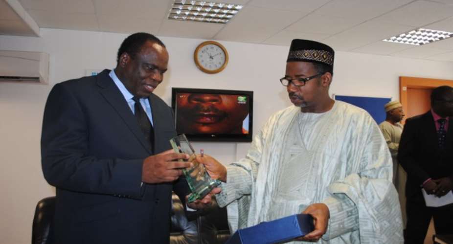 PHOTO: R-L; FCT MINISTER, SENATOR BALA ABDULKADIR MOHAMMED PRESENTS A GIFT TO VISITING ZAMBIAN HIGH COMMISSIONER TO NIGERIA, MR. ALEXIS CADMAN LUHILA, DURING A COURTESY VISIT TO THE MINISTER IN ABUJA TODAY, AUGUST 25, 2010.