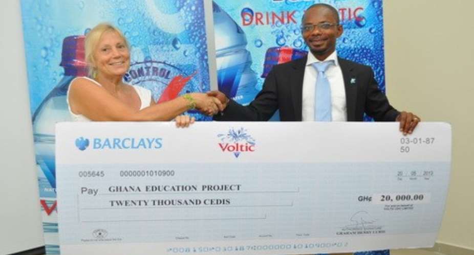 Cyrus deGraft-Johnson, Corporate Affairs Manager of Voltic (GH) Limited presenting the cheque to Gillian Norris, Founder of GEP.
