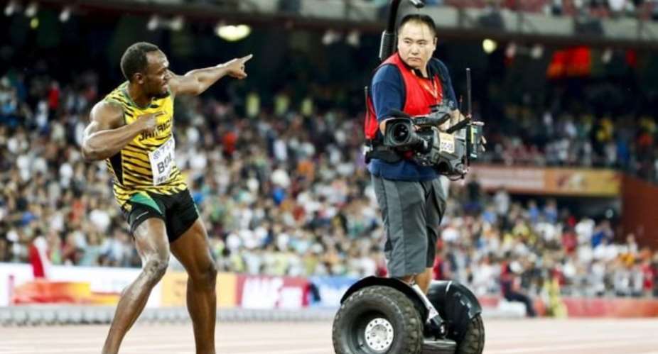 Usain Bolt knocked down in Beijing - in pictures