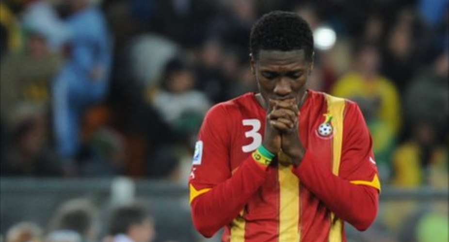 Distraught Asamoah Gyan after he missed the penalty shot against Uruguay