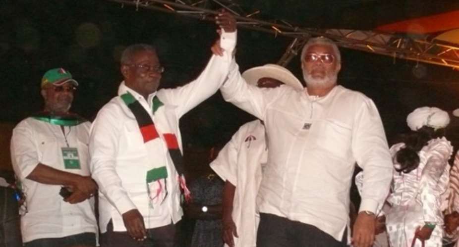 President Mills has his hand lifted in victory by ex-President Jerry Rawlings