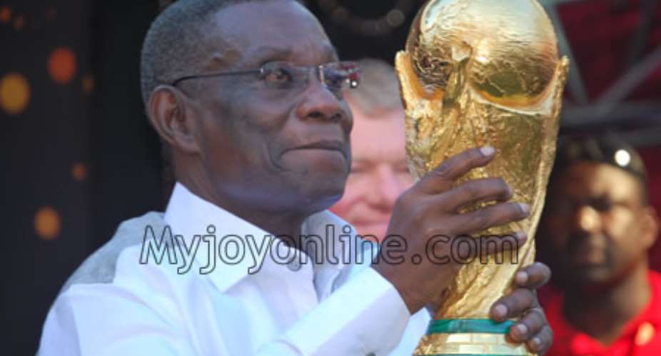 President John Evans Atta Mills with the FIFA World Cup Trophy he said he was loaning out