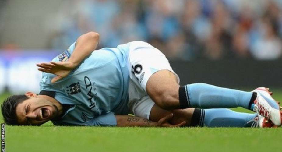 Sergio Aguero grimaces in pain after the deadly tackle