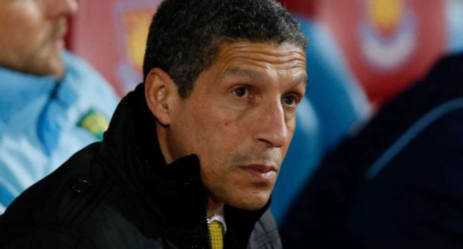 Chris Hughton looks on from the dugout before the start of their English Premier League soccer match against West Ham United at Upton Park, London