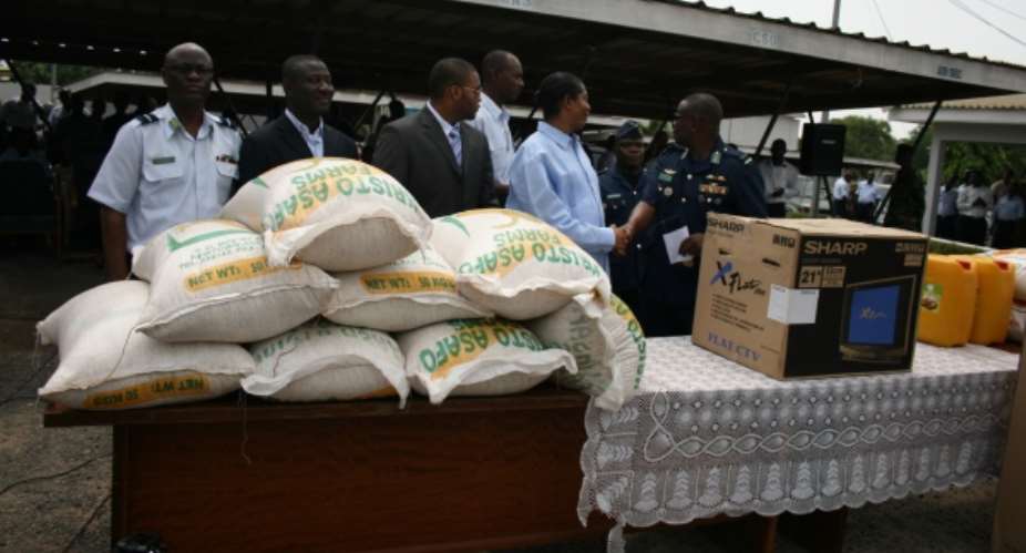 Dr Apostle Kwadwo Safo, founder of Kristo Asafo Church,presenting items to Air Force Marshall Micheal Samson Oje, Chief of AirForce Staff, looking on are other Air Force officers.