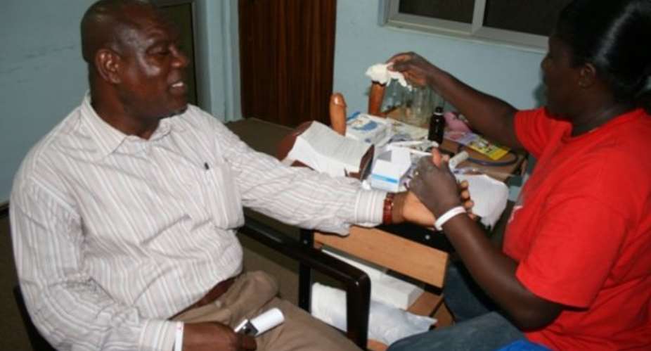 Mr Bright Blewu, General Secretary of GJA testing his status from Madam Marcy Acquah-Hayford, a testing officer.