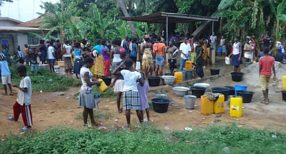 Some of the indigenes of the Lower Manya Krobo Traditional Area struggling over water from one of the boreholes in the community.