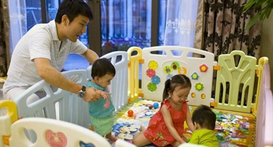 Happy Family: Tony Jiang poses with his three children at his house in Shanghai September 16, 2013. In December 2010,the Shanghai businessman and his wife welcomed a daughter, born in California by an American surrogate