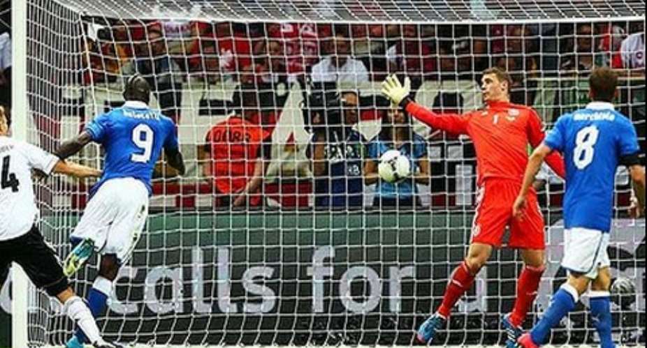 Mario Balotelli (2nd left) scores the opening goal past Manuel Neuer of Germany during the UEFA EURO 2012 semi final in Warsaw