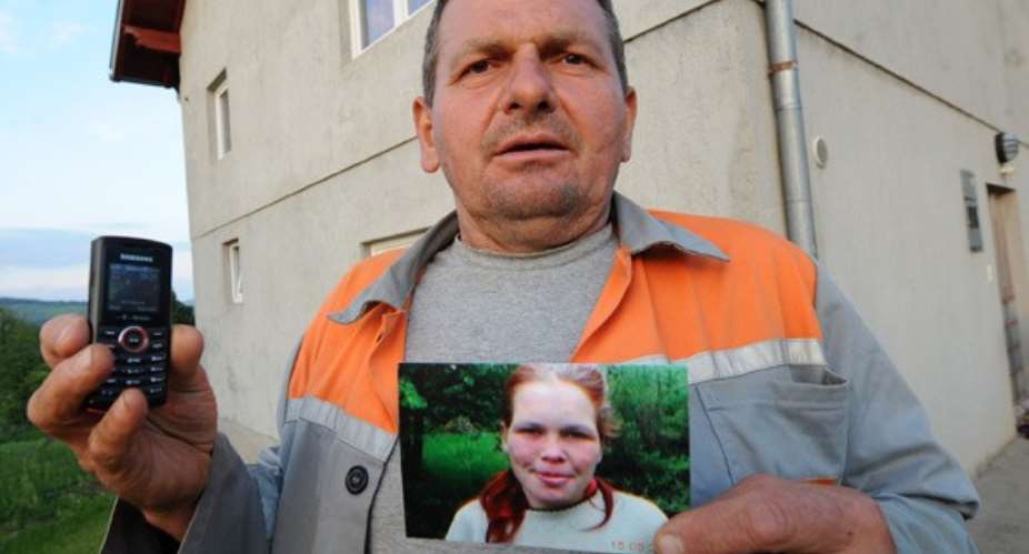 AFPGetty Neighbour Sead Makalic poses with his cellphone and a picture of the German girl