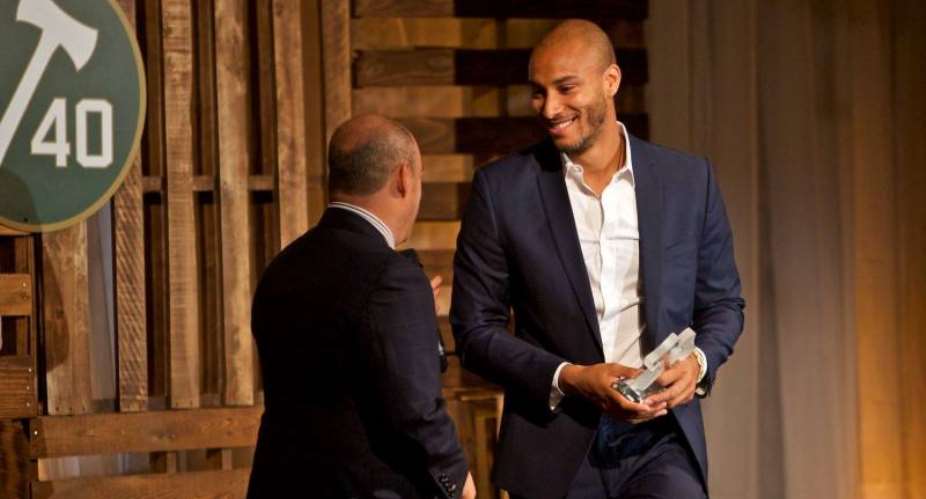 Adam Kwarasey receives the community player of the year award from Timbers president of business operations Mike Golub during the 2015 Stand Together Banquet at the Nines Hotel. Photo: Craig Mitchelldyer-Portland Timbers