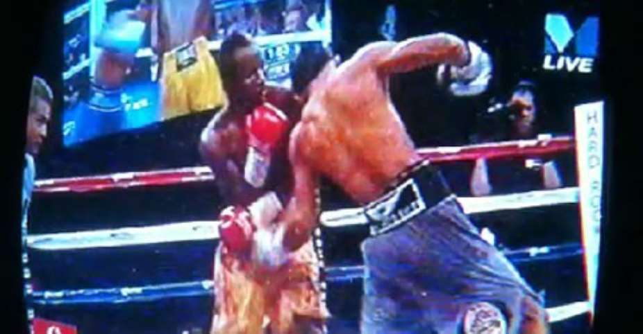 Caught in the act! Mares drives a massive punch into Agbekos vital area and close by, on the left, a blinded Russel Mora calls it fair!