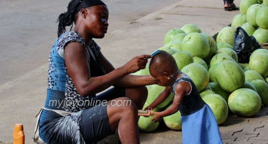 Photo of the week: A water melon seller dresses up her daughter for school