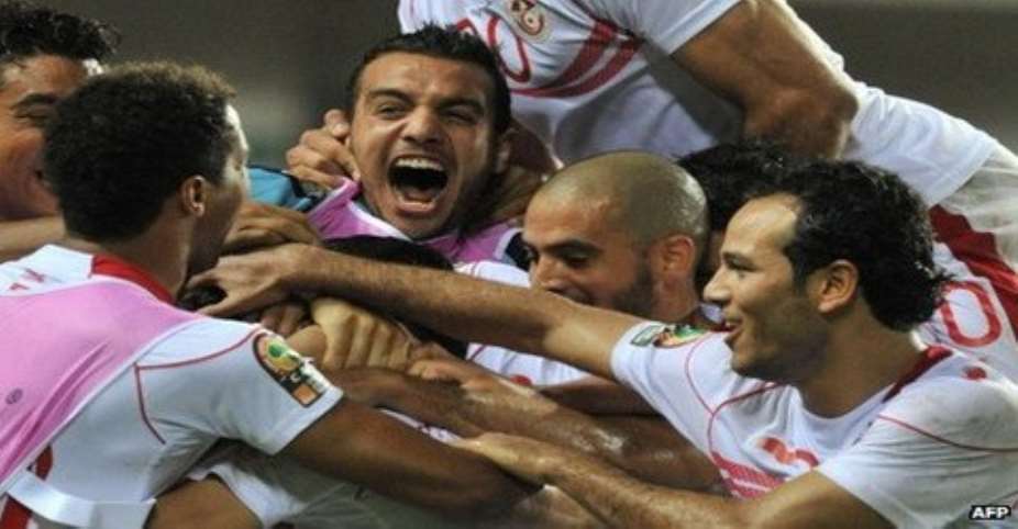 Tunisia's players celebrate a massive opening win over neighbours Morocco