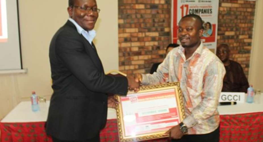 Richard Ahiagble (L), Corporate Citizenship Manager, GGBL receiving the award from Mr. Seth Twum–Akwaboah, Executive Director of the Association of Ghana Industries
