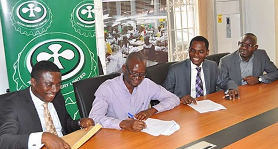 Akature Ania, HR Director of ABL 2nd from L signing the training grant as officials of SDF look on. L-R Dunwell Eku, Grants Specialist, Ebenezer Ato Simpson SDF Manager and Nyadia Sulemana Nelson, Grants Officer.