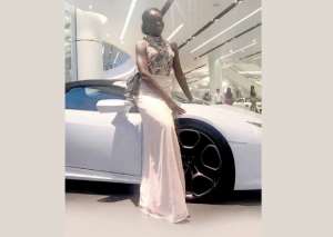 Afua Asieduwaa Akrofi standing by the fast car