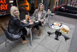 A drone brings food to customers at YO! Sushi Restaurant in London- Photo credit: Neil Hall / Reuters