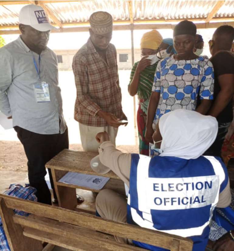 The  Executive Director of the NDDI who also doubled as the Head of the NDDI Election   Observer Team in charge of the Upper East Region, Mr Mustapha Sanah (Standing Left ) at Zamse Sec/Tech Polling Station in Bolgatanga