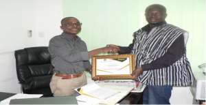 Business Development Manager of Alliance Waste, Mr. Seth Maclean Acquah, (L), receiving a certificate of honour from the Communications Director of HMI, Mr. Abdallah Musah (R).