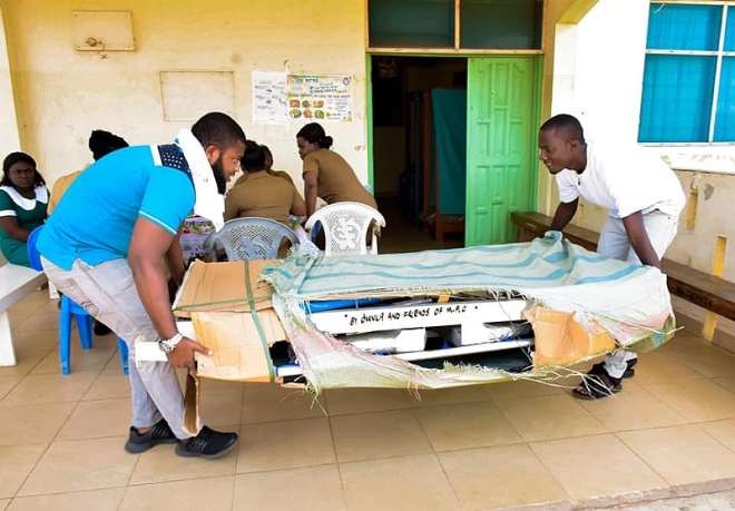 Prince Amarh (in White) And Another Youth Of Tema Conveying The Strecther To The Polyclinic