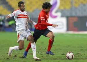 Kodjo Fo-Doh Laba (L) of Renaissance Berkane holds off Hamza Mathlouthi of CS Sfaxien during the first leg of a CAF Confederation Cup semi-final. Sfaxien won 2-0 at home with Mathlouthi scoring the second goal..  By STR (AFP)