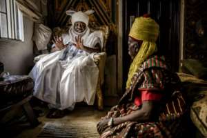 Taking counsel: Clad in his traditional turban, the Sarkin Fulani discusses issues with his assistant. Stigma is one of the biggest problems facing Fulani today, the king says. By Luis TATO (AFP)