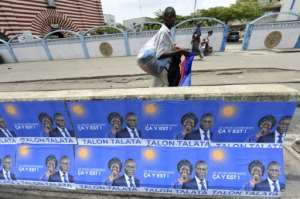 Talon, seen here with his running mate Mariam Talata on campaign posters in Cotonou, is expected to win on Sunday. By PIUS UTOMI EKPEI (AFP)