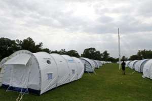 Tent city: Homeless people are being temporarily housed under canvas at the Pretoria West Rugby Stadium. By Phill Magakoe (AFP)