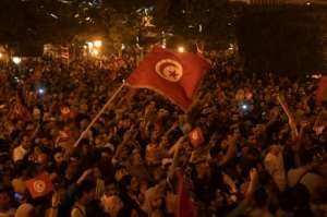 Thousands of people took to the streets of the capital Tunis to celebrate Saied's victory, honking horns and singing the national anthem. By Fethi Belaid (AFP)