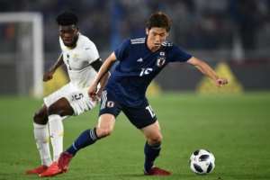 Thomas Partey (L) playing for Ghana against Japan in a friendly international match. By Martin BUREAU (AFP/File)