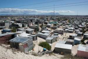 The corrugated-iron shacks typically house between three and seven people -- hot, cramped conditions that are made even worse by the lockdown. By RODGER BOSCH (AFP)