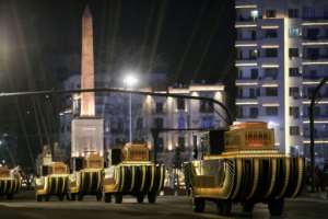 The carriages carrying 22 ancient Egyptian royal mummies advance past the Obelisk of Ramses II along Tahrir Square as they depart from the Egyptian Museum to their new home. By Mahmoud KHALED (AFP)
