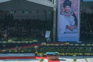 The casket of South African anti-apartheid icon Winnie Mandela is displayed at a pre-burial service at a stadium in Soweto on Saturday. By MUJAHID SAFODIEN (AFP)
