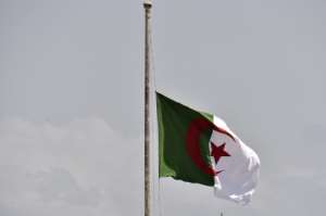 The Algerian national flag flies at half mast in the capital Algiers on September 18, 2021, before the funeral of former president Abdelaziz Bouteflika. By RYAD KRAMDI (AFP)