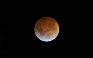 The Earth's shadow almost totally obscures the view of the so-called Super Blood Wolf Moon during a total lunar eclipse.  By Ezequiel BECERRA (AFP)