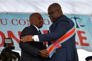 The formation of the new government by Felix Tshisekedi is closely monitored for signs that his predecessor, Kabila, will continue to dominate the country's politics. Kabila, on the left, is shown here pbading power in Tshisekedi
in January. By TONY KARUMBA (AFP / File)