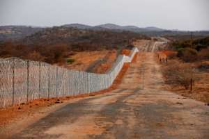 The fence separating South Africa and Zimbabwe has been notoriously porous since its de-electrification in 1994. By Phill Magakoe (AFP)