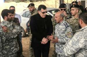 The head of Libya's UN-backed unity government Fayez al-Sarraj meets commanders who helped retake a key checkpoint south of Tripoli. By Mahmud TURKIA (AFP)