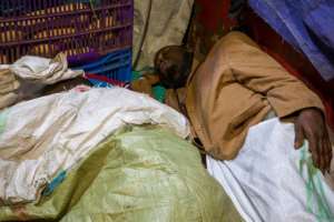 The less fortunate are forced to sleep in the open, curled up on sheets of cardboard or hessian sacks in a vain attempt to keep warm. By Badru Katumba (AFP)