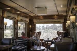 The massive windows of the observation car offer views of the landscapes and cityscapes along the Blue Train's route. By MARCO LONGARI (AFP)