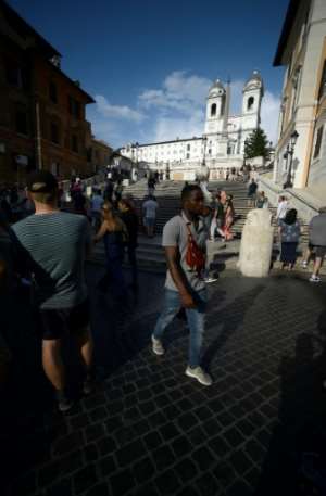 The migrants hand out audio guides and lead walking tours in English and Italian. By Filippo MONTEFORTE (AFP)